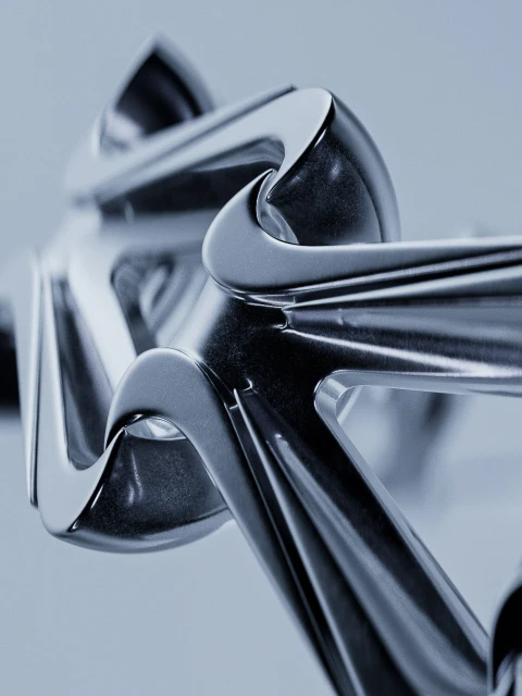 Macro abstract design featuring reflective chrome or silver metal geometric shapes with curved lines and smooth, polished surfaces.