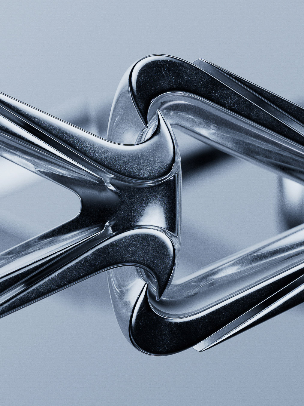 Close-up studio shot of interconnected silver metal forms with rounded edges and sleek surfaces on a light blue gradient backdrop.