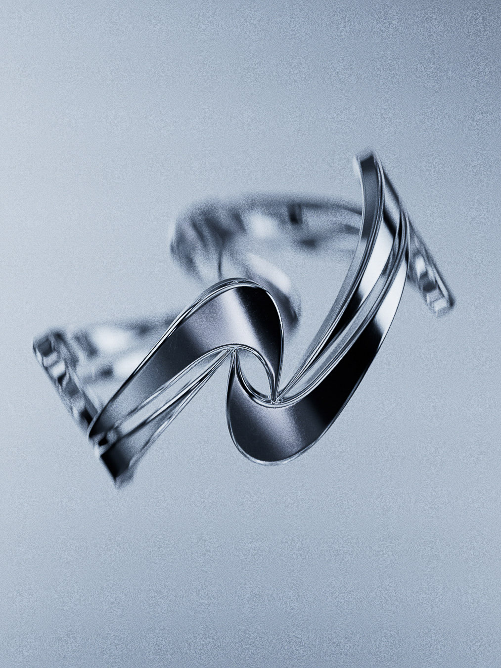 Abstract silver metal ribbon sculpture on pale blue background. Studio photography emphasizing form, texture, and minimalist composition.