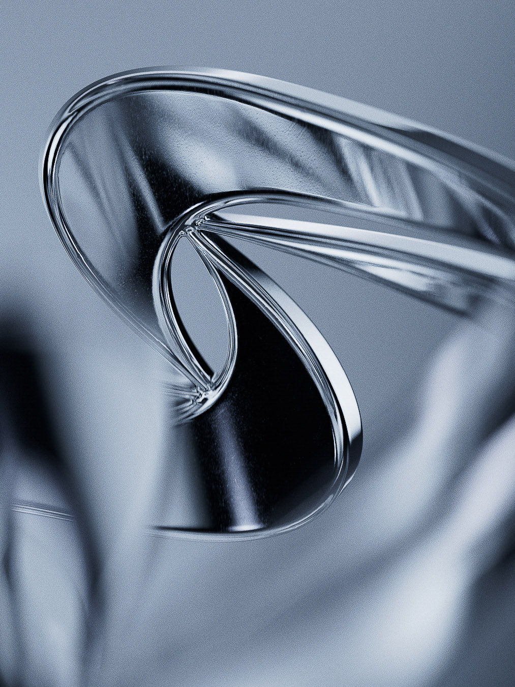 Abstract close-up of a curved, shiny metal object, featuring reflections and smooth surfaces against a soft grey background.