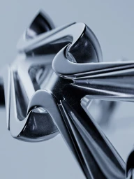 Close-up 3D CGI rendering of interlocking metallic chrome Nike swoosh forms with glossy reflections against a pale blue gradient.