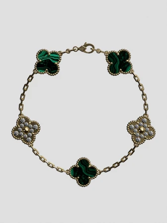 Elegant gold bracelet featuring four-leaf clover charms with malachite and diamond accents, creating a luxurious and stylish jewelry piece.