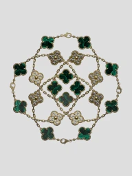 Van Cleef & Arpels gold Alhambra bracelets with malachite and diamond clover motifs arranged in a symmetrical geometric design.