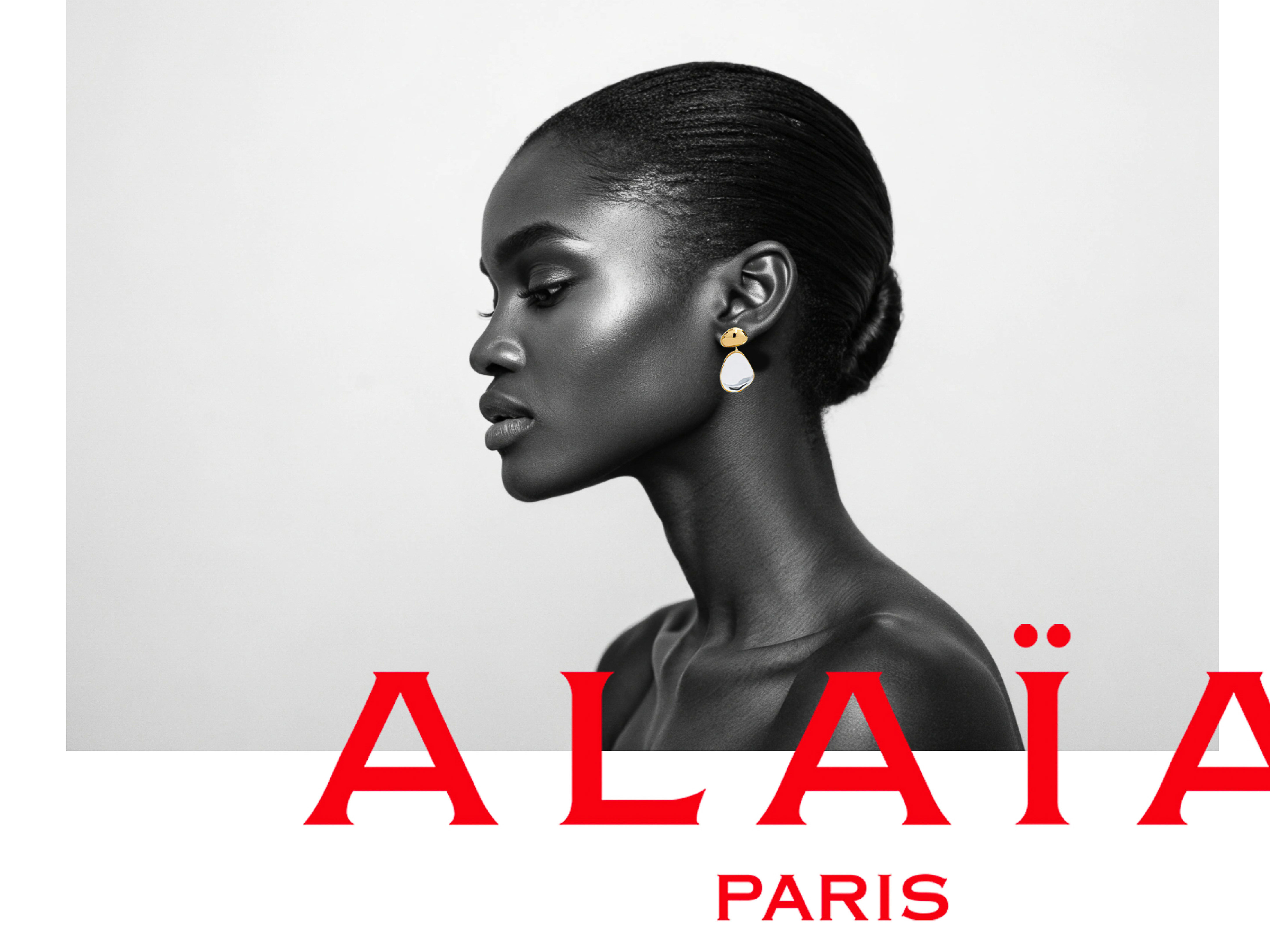Close-up studio portrait of an African woman with smooth skin and elegant earrings, set against a clean white background with fashion brand text.