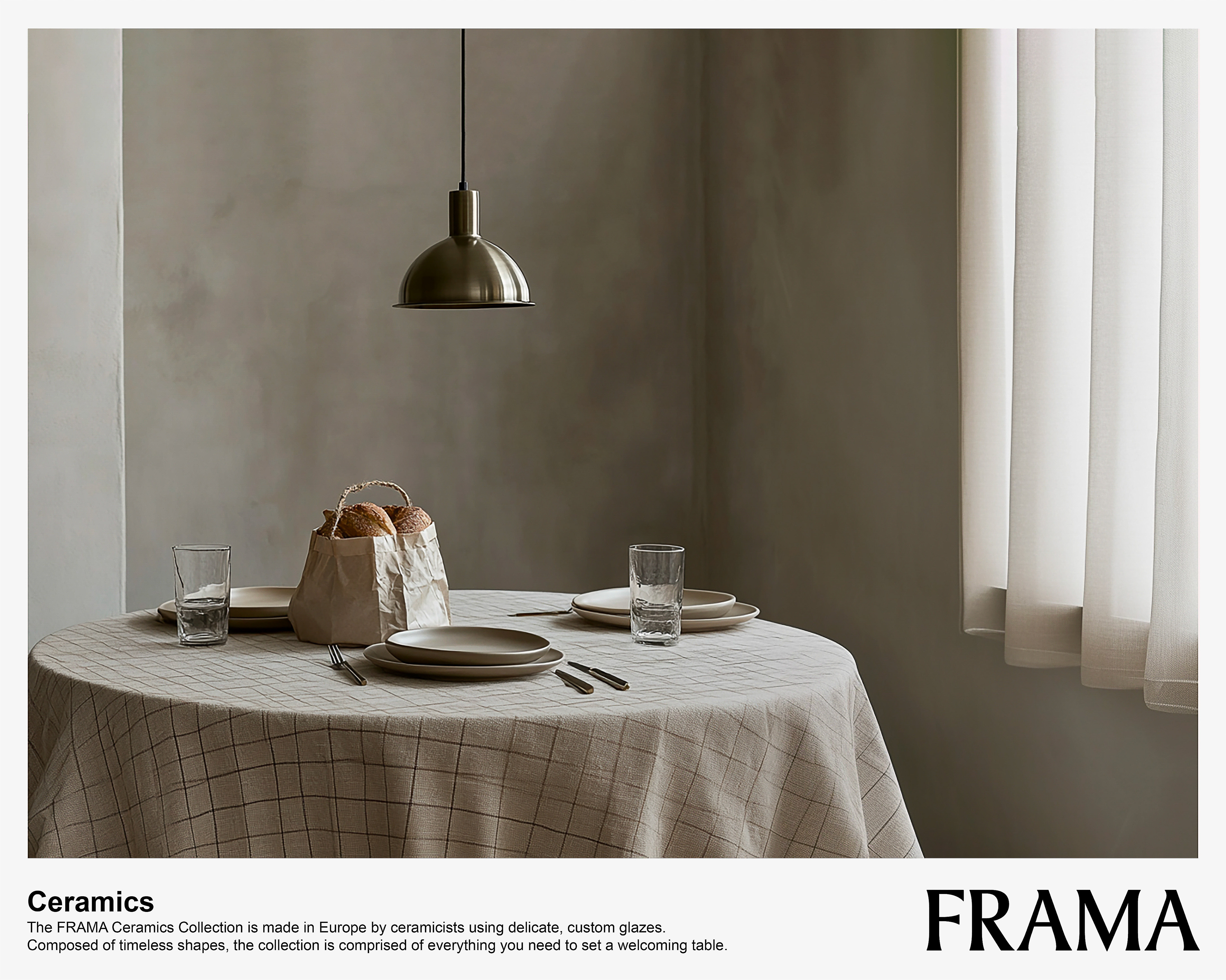 Dining room setup featuring a round table with a checkered tablecloth, plates, glassware, cutlery, a hanging light fixture, and window.