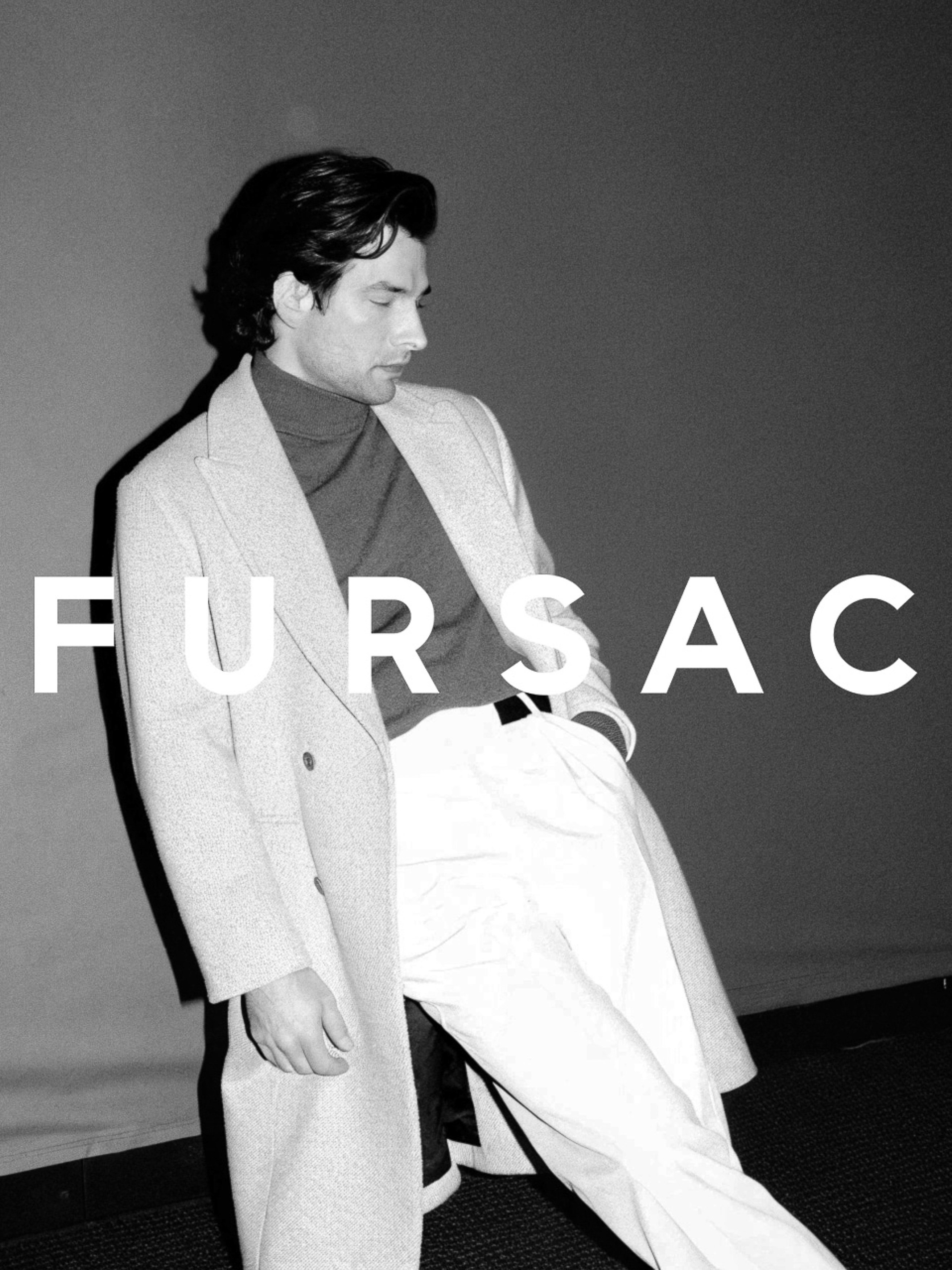 A fair-skinned adult male poses in a gray double-breasted overcoat and white pants indoors, with 'FURSAC' text overlay in white.