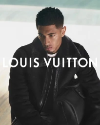 Jude Bellingham wearing a black shearling jacket and holding a black leather duffle bag for Louis Vuitton campaign