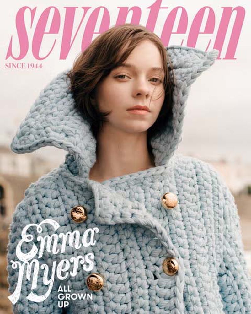 Magazine cover featuring Emma Myers wearing a light blue knitted hooded jacket with gold buttons, against a blurred outdoor background.