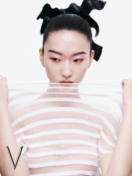 Model Tao Quan in a white striped top with dark bows in her hair for V Magazine China photographed by Rambo Ding.