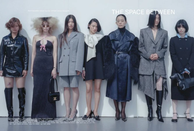 Group of seven Asian female models wearing assorted stylish dresses, suits, and boots in a fashion editorial shot against a white wall.