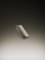 A motion-blurred cylindrical container floating diagonally in mid-air against a smooth gradient background.