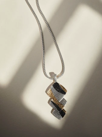 John Hardy geometric pendant necklace with hammered gold, pavé crystals, and black stones on a silver woven chain.