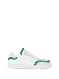 Side view of a white leather low-top sneaker with green crochet trim on a clean white background.