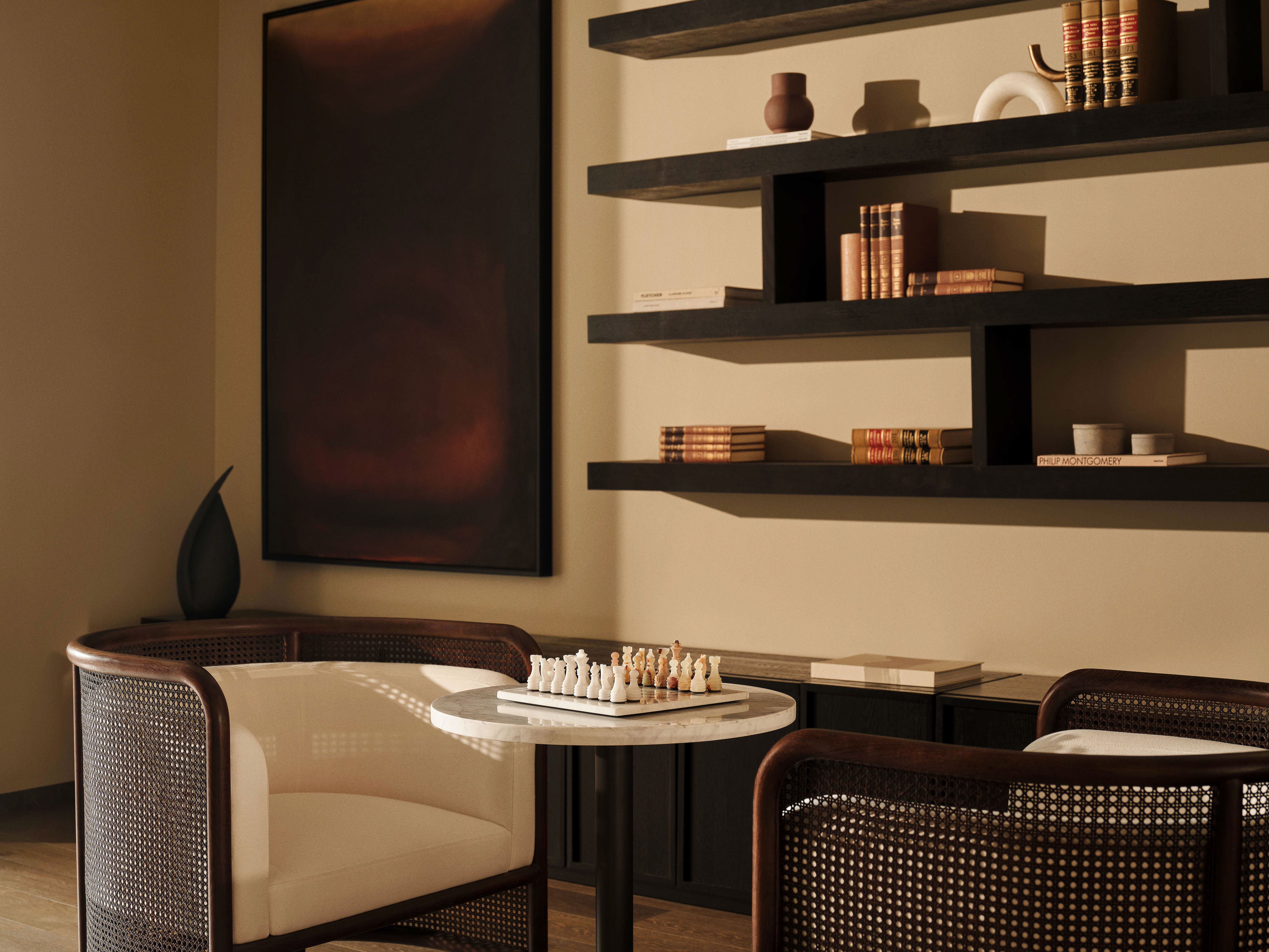 Interior design features seating near a chess set on a marble table, set against a backdrop of floating shelves with decorative objects.