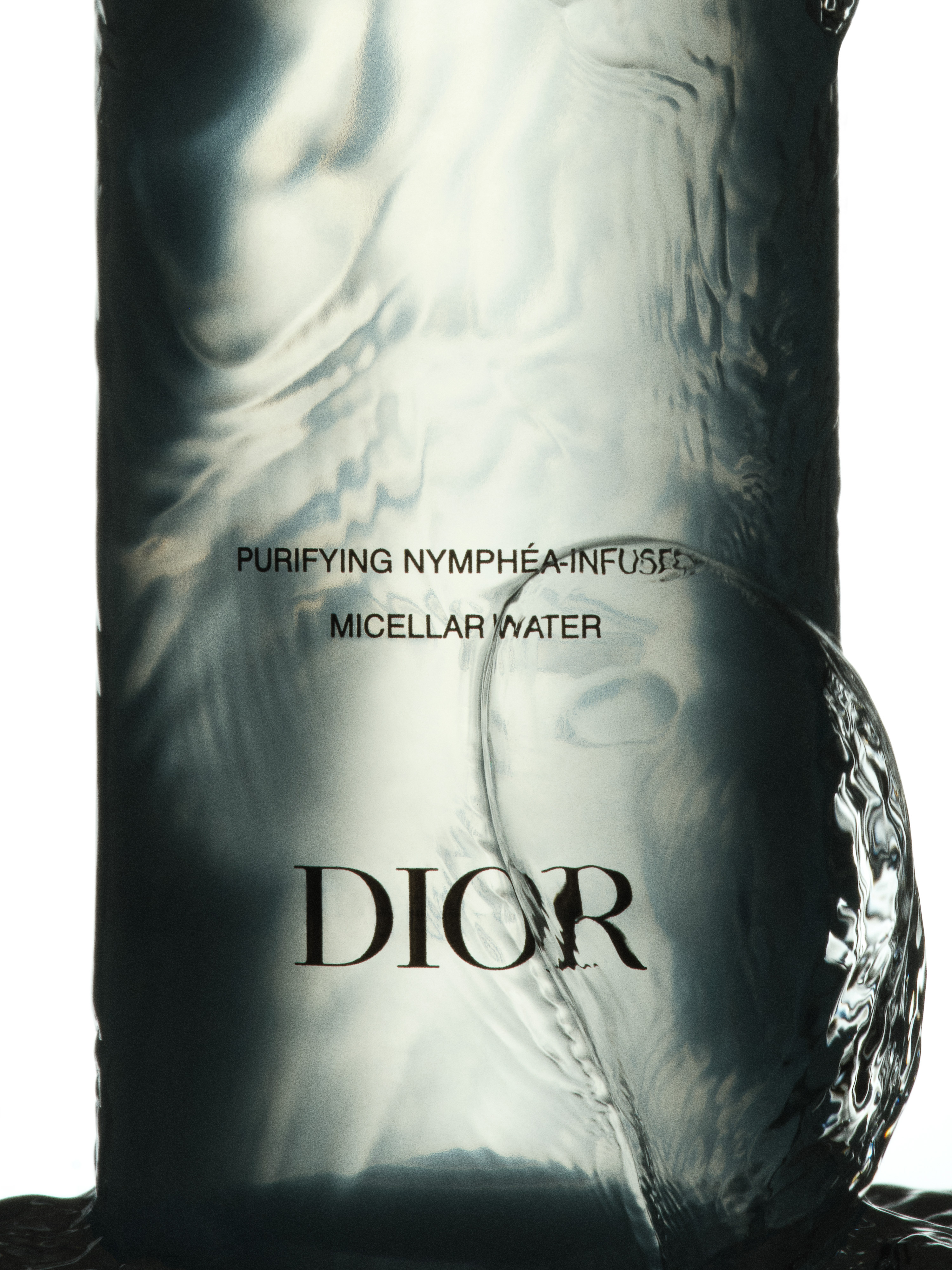 Dior micellar water bottle in a close-up product shot featuring translucent liquid and the brand's logo against a white background.