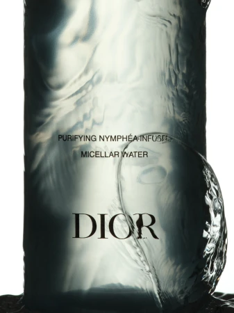Dior micellar water bottle in a close-up product shot featuring translucent liquid and the brand's logo against a white background.