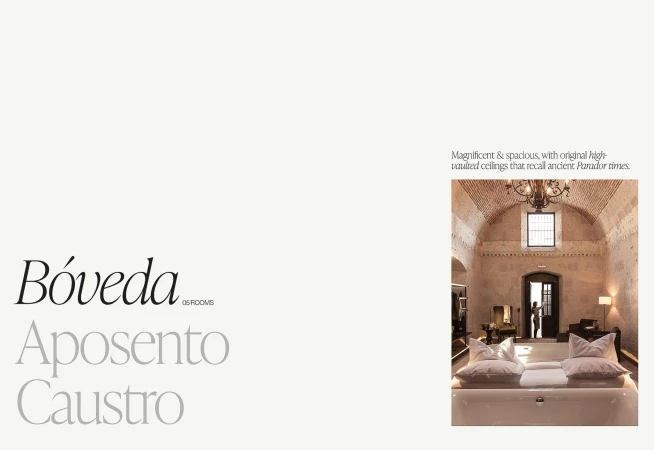 Hotel interior showcasing a spacious room with vaulted ceilings, a chandelier, neutral tones, and a minimalist design aesthetic.