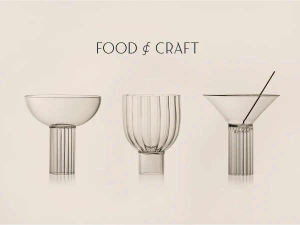 Three clear glass vessels with ribbed pedestal bases on a light background, showcasing minimalist design for food and craft presentation.