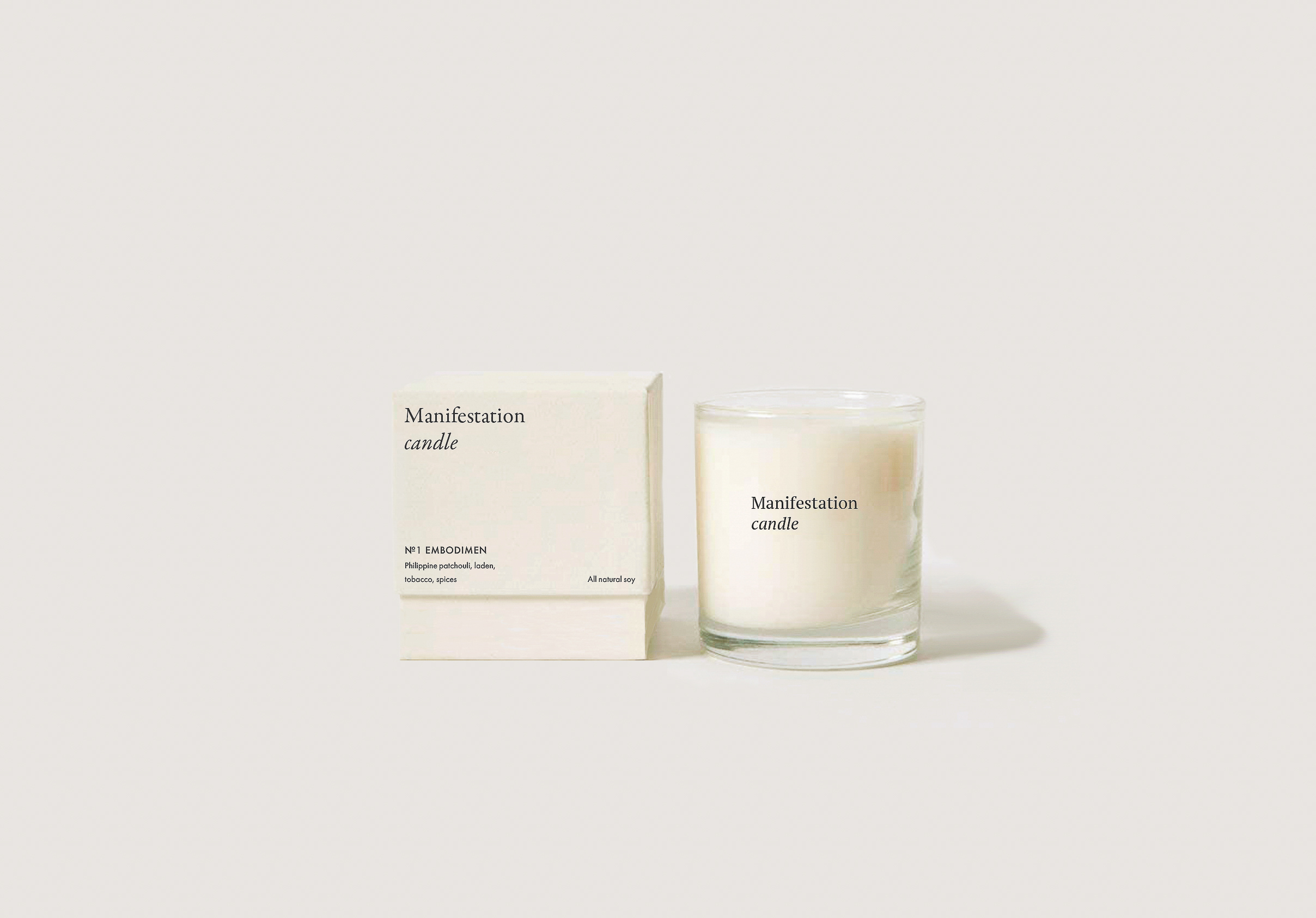 A small glass jar candle and its packaging are staged on a white background, creating a simple and clean presentation of a home fragrance product.