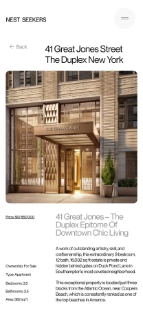 Exterior of a modern brick apartment building with a covered entrance. Natural light illuminates the building facade and entrance.