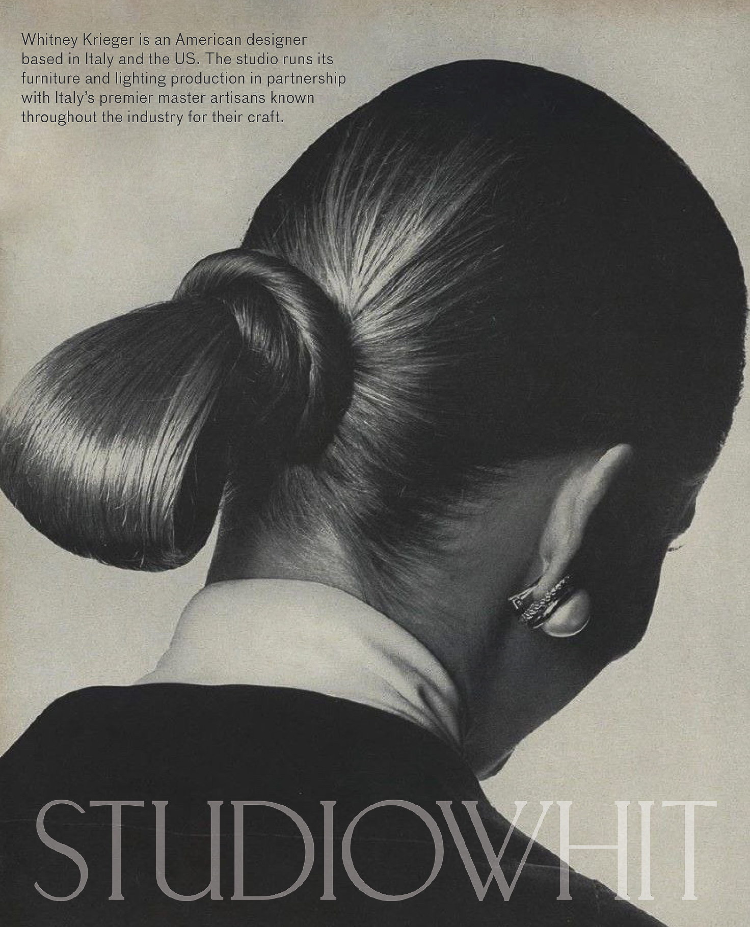Monochrome studio shot of woman with elegant updo and statement earrings facing away; neutral backdrop, stylish and sophisticated visual.