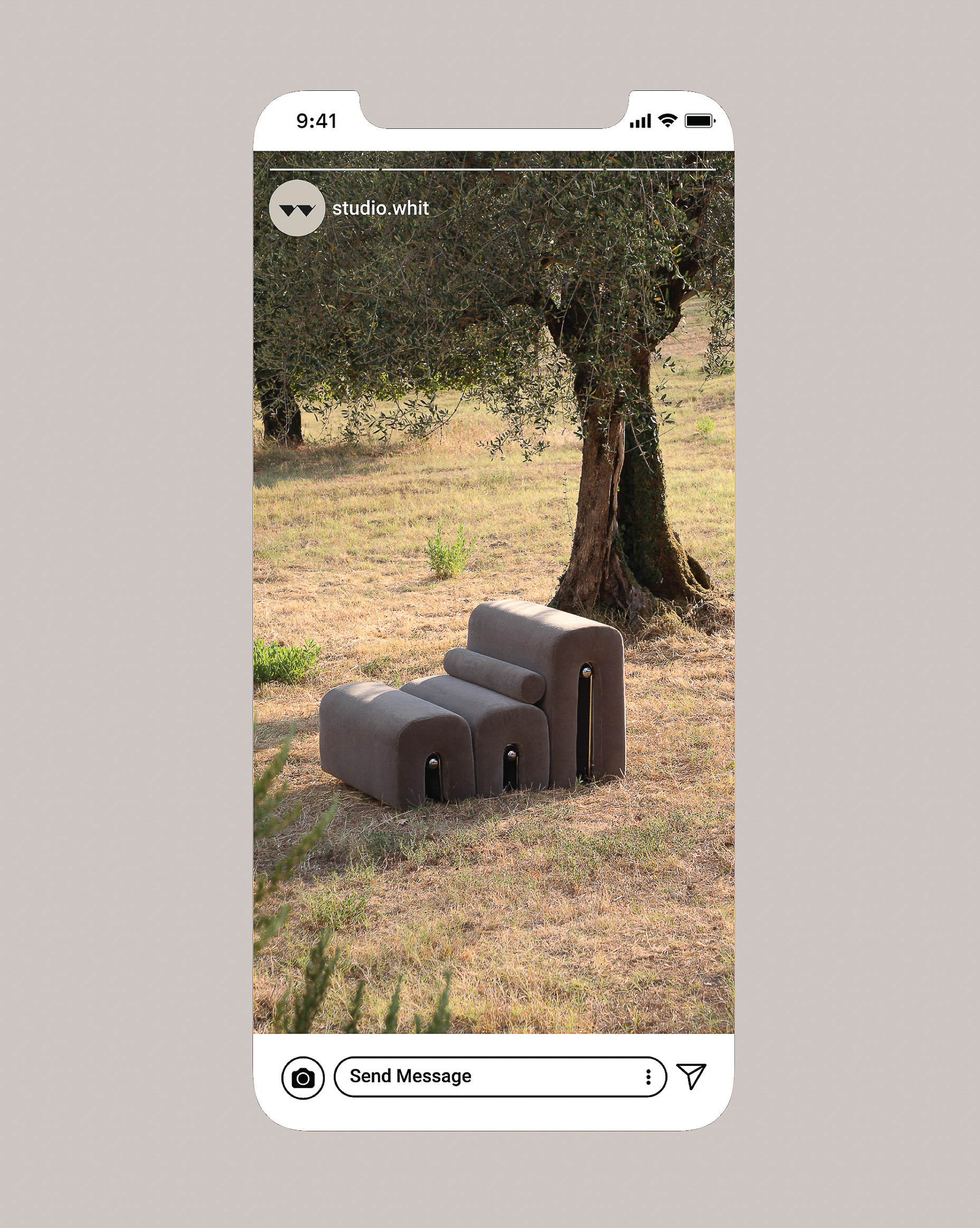 Grey modular lounge chair sits on brown grass beneath a tree, displayed on a smartphone screen, simulating an Instagram post.