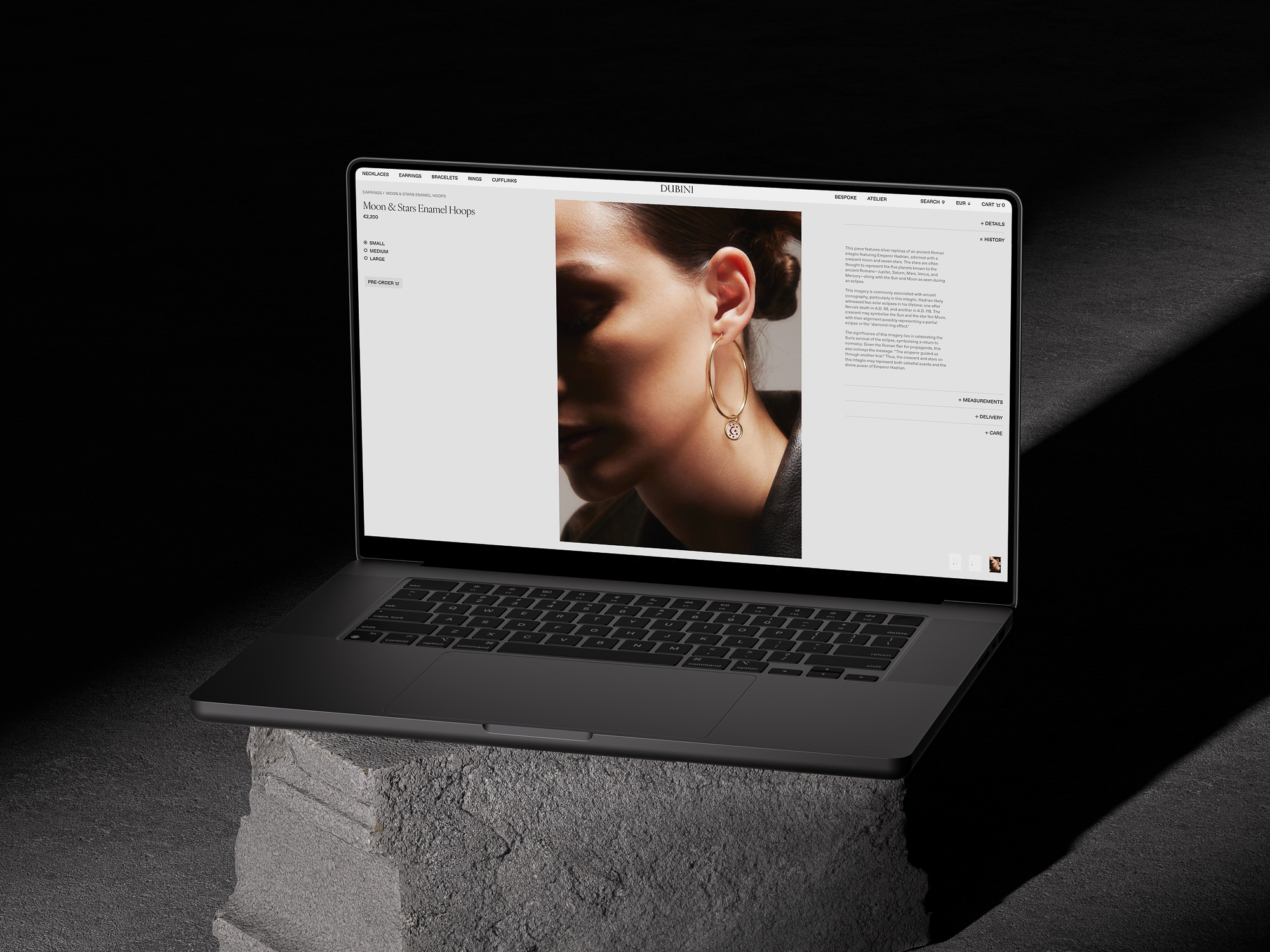 Laptop displays woman with earring, stone base, and dark background. Perfect for beauty, fashion, and technology industries.