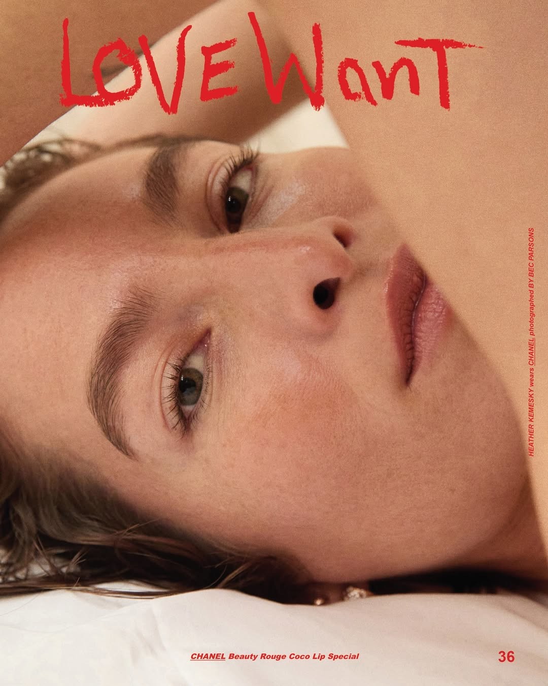 Close-up beauty portrait of a woman lying down with natural skin texture and soft lighting, for Love Want magazine editorial.