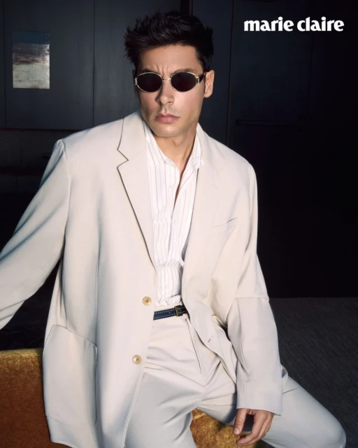 Model Andrea Denver wearing a light-coloured suit and sunglasses in an editorial portrait for Marie Claire Serbia.