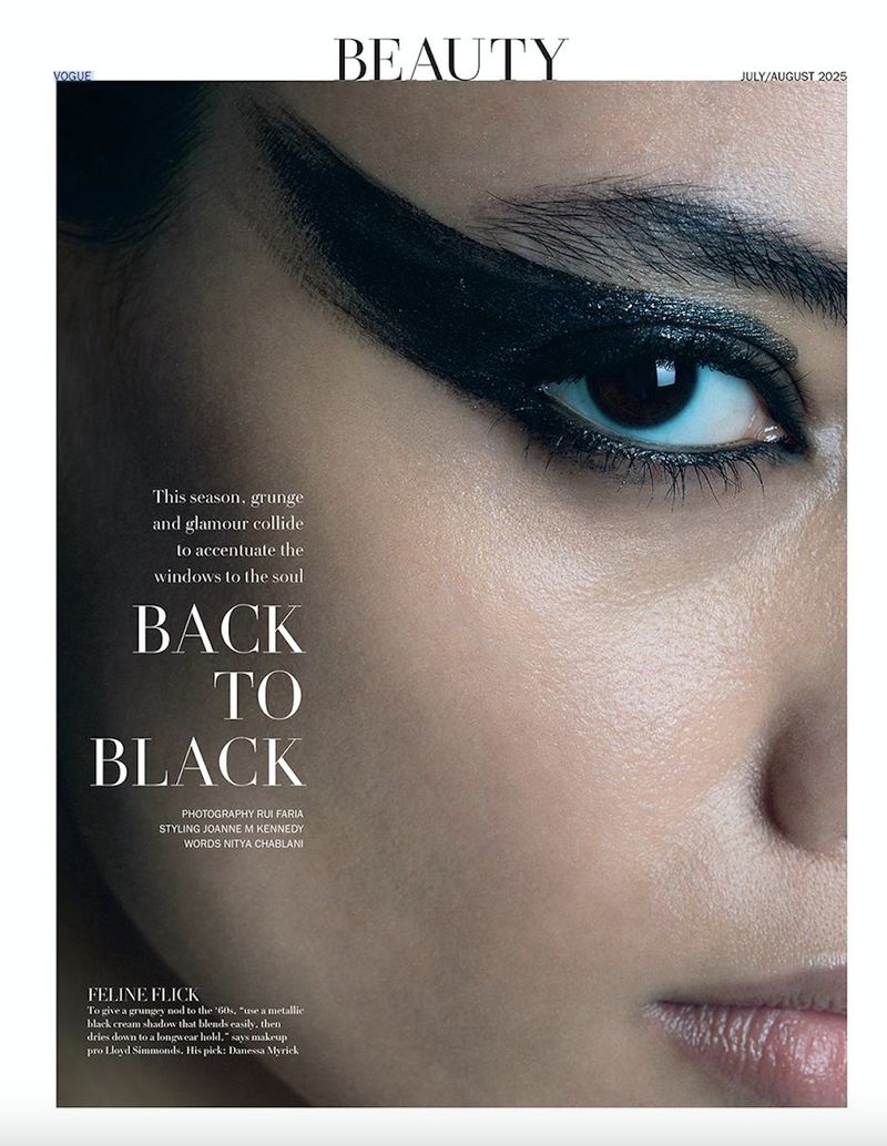 Close-up of a woman's face with heavy, stylized black eyeliner, dramatic makeup, and a beauty magazine cover aesthetic.