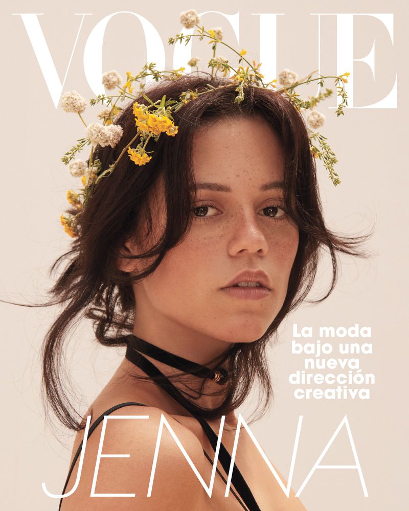 Vogue magazine cover featuring a woman with a flower crown, wearing a black choker, against a light peach background, with overlaid text.