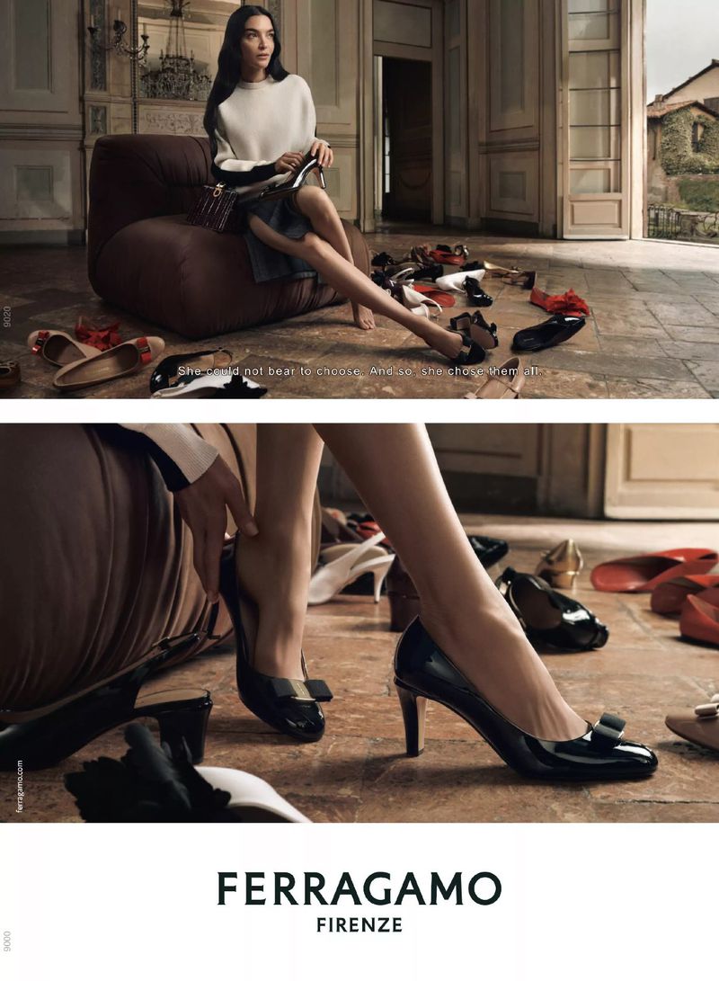 Fashion advert showcasing a woman seated on a chair surrounded by shoes, with a close-up of a woman's hand adjusting a black high heel.