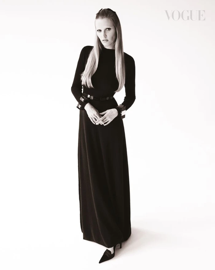 Model Lara Stone wearing a long black dress and belt against a plain white background for Vogue Singapore
