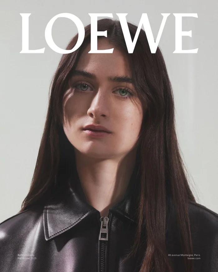 Portrait of Raffey Cassidy wearing a black leather jacket against a white backdrop for Loewe Fall Winter 2025 Campaign