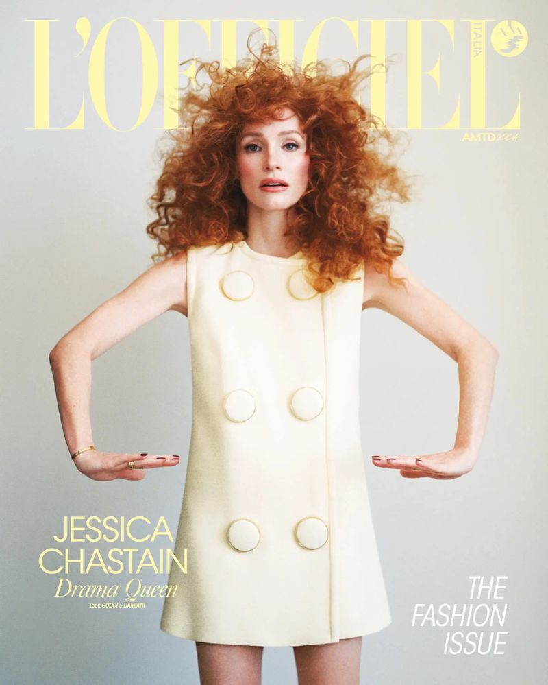 Fashion magazine cover featuring Jessica Chastain with voluminous red hair, wearing a vintage-style cream dress against a pale backdrop.