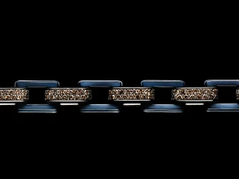Close-up of a diamond and ceramic link bracelet by David Yurman against a deep black background