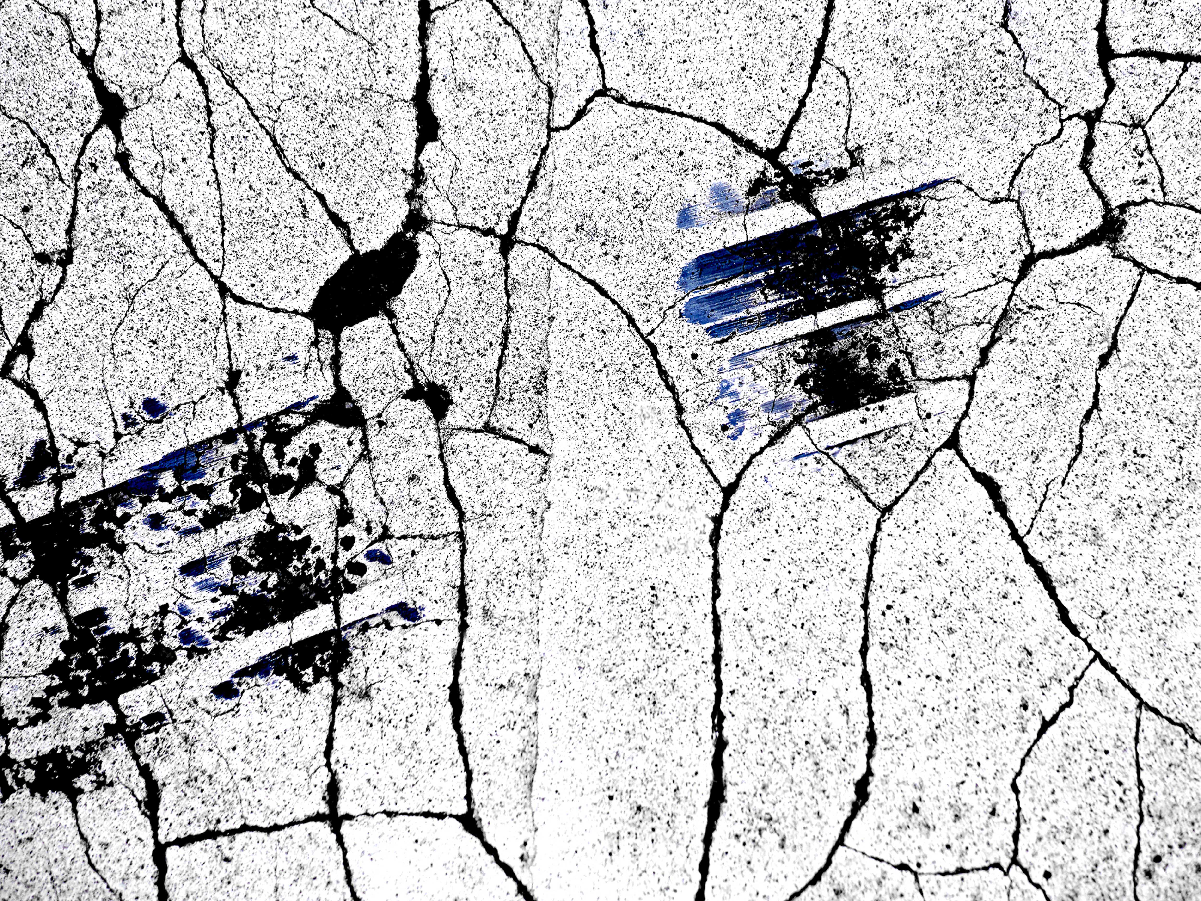 Abstract background with cracked concrete texture and blue streaks, creating a distressed and artistic visual for various design applications.