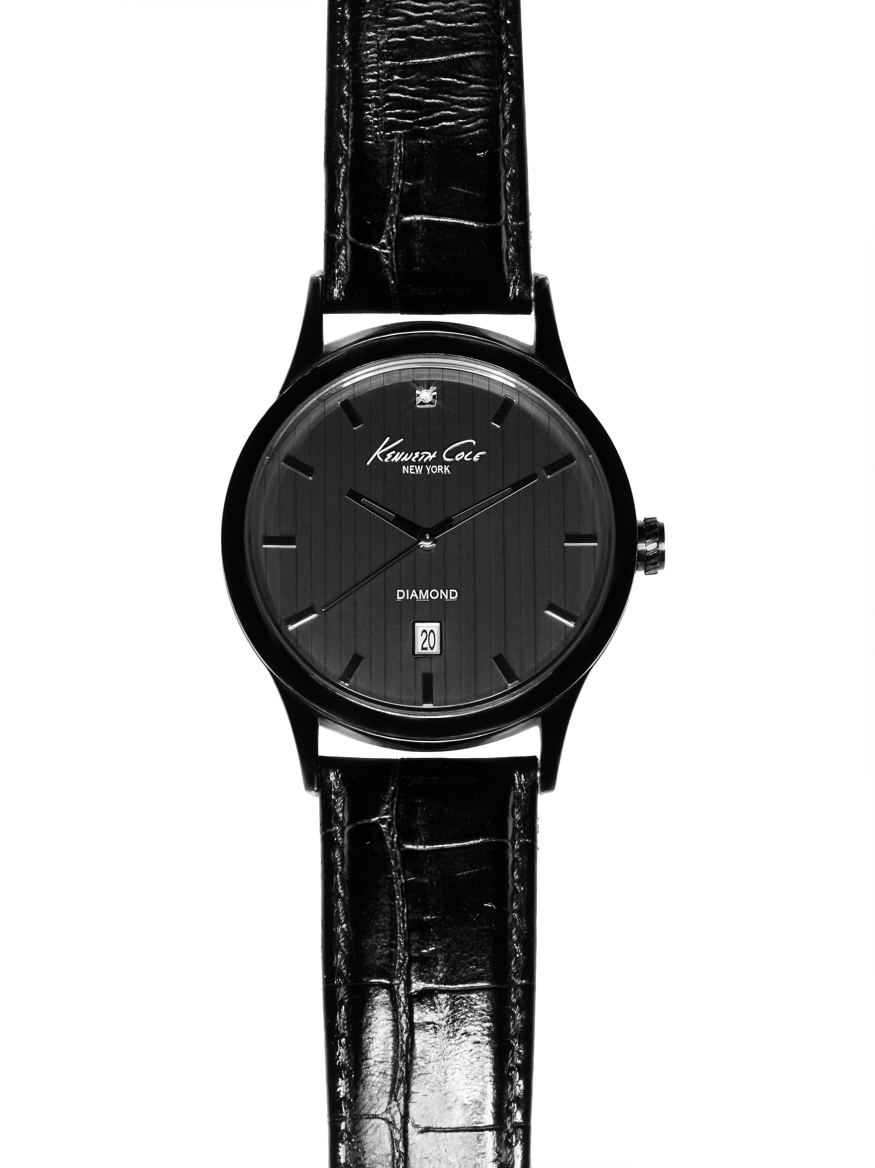 Black Kenneth Cole New York watch featuring a leather band and date window on a white background. Timepiece close-up in studio.