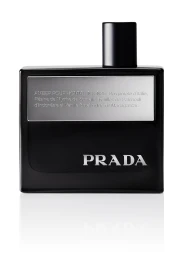 Prada Amber Pour Homme Intense black cologne bottle with silver plaque and logo on a reflective white surface.
