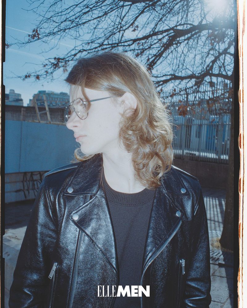 Oskar Marklund in profile wearing a black leather biker jacket and wire-frame glasses for Elle Men Thailand.