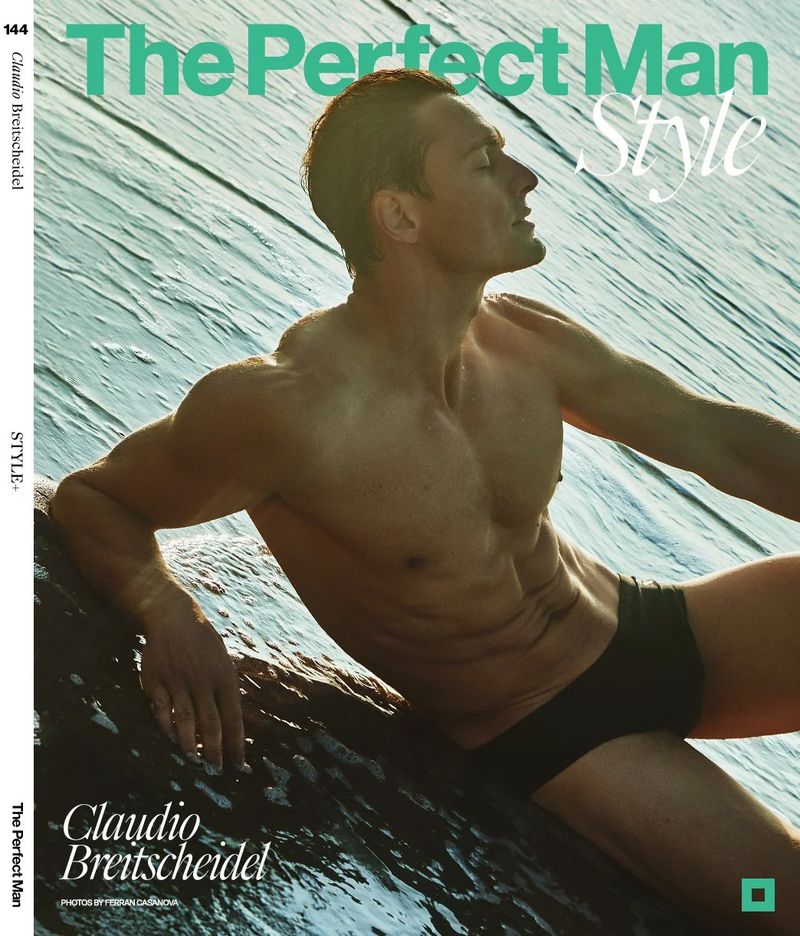 Fit adult male with bare torso wearing black swimwear on a rock near ocean water with magazine cover text in a studio shot.
