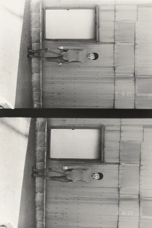Black and white split frame of Meg Fuji wearing a long sleeve bodysuit and cap, standing against a corrugated metal wall.