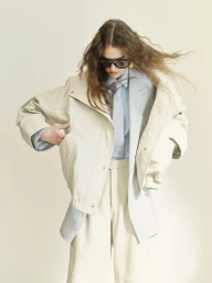 Model Gwen Weijers wearing an oversized cream jacket and sunglasses for The Greatest Magazine editorial