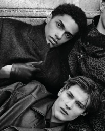 Monochrome close-up of male models in leather and wool outerwear for the Emporio Armani F/W 2025 campaign.