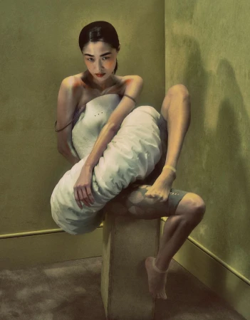 Digital painting features a woman sitting on a cube, wrapped in white fabric against a textured green wall, rendered in a painterly style.