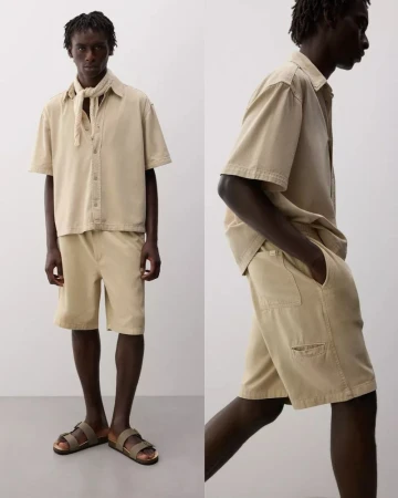 Model Godwin Dekou wearing a beige short-sleeve shirt and matching shorts for the Lefties S/S 25 collection.