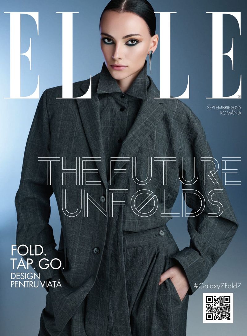 A female model in a dark gray plaid suit poses on the cover of ELLE magazine.