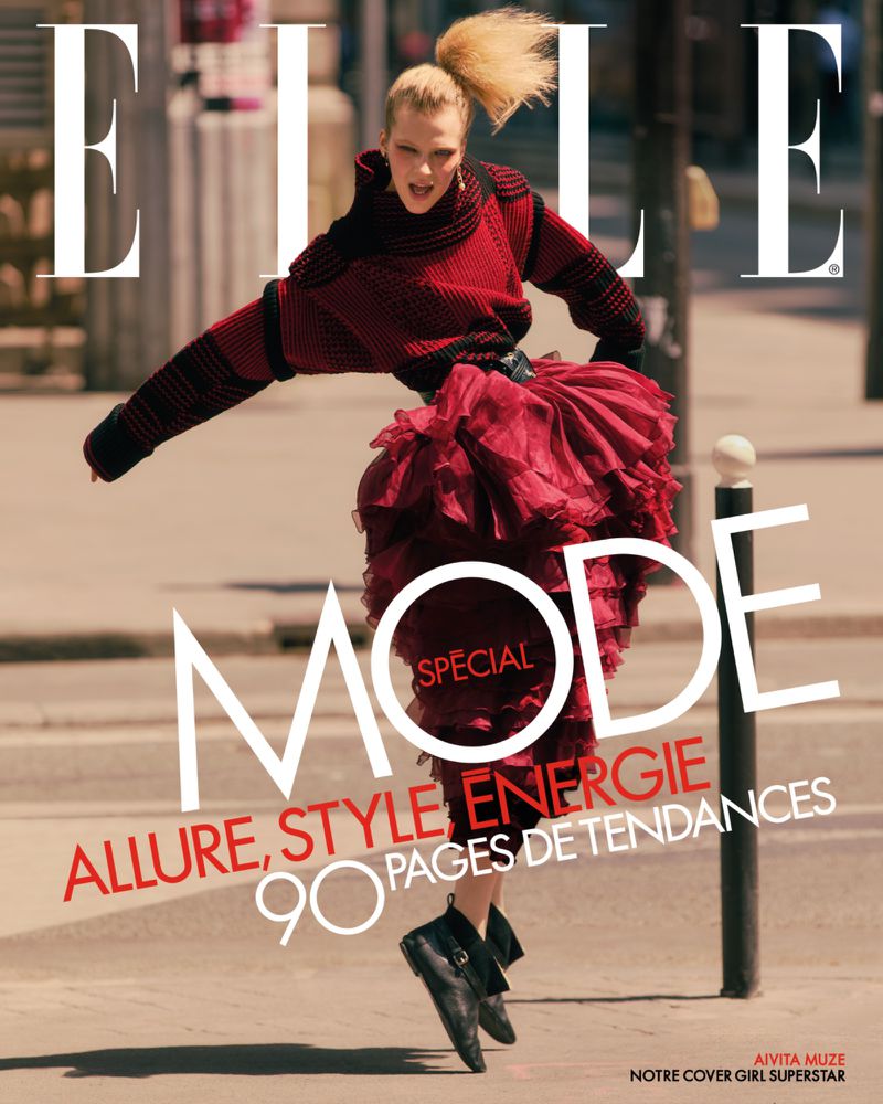 Elle magazine cover featuring a blonde adult female model in a red ruffled dress, jumping mid-air on a city street with bold text.
