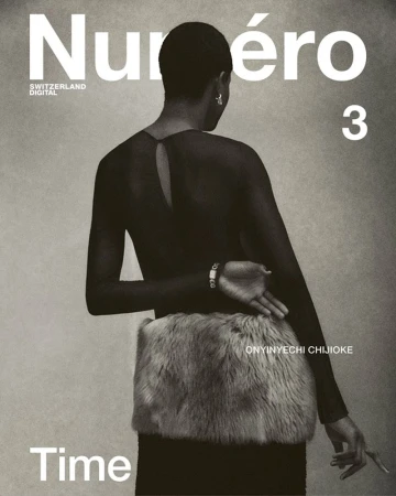 A woman with short dark hair is seen from the back, wearing a sheer top and skirt with fur detail, for a Numero magazine cover.
