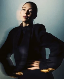 Vanessa Kirby in a dark structured blazer against a moody gradient background for a Vogue Czechoslovakia editorial portrait.